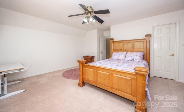 bedroom featuring lofted ceiling, light colored carpet, baseboards, and ceiling fan