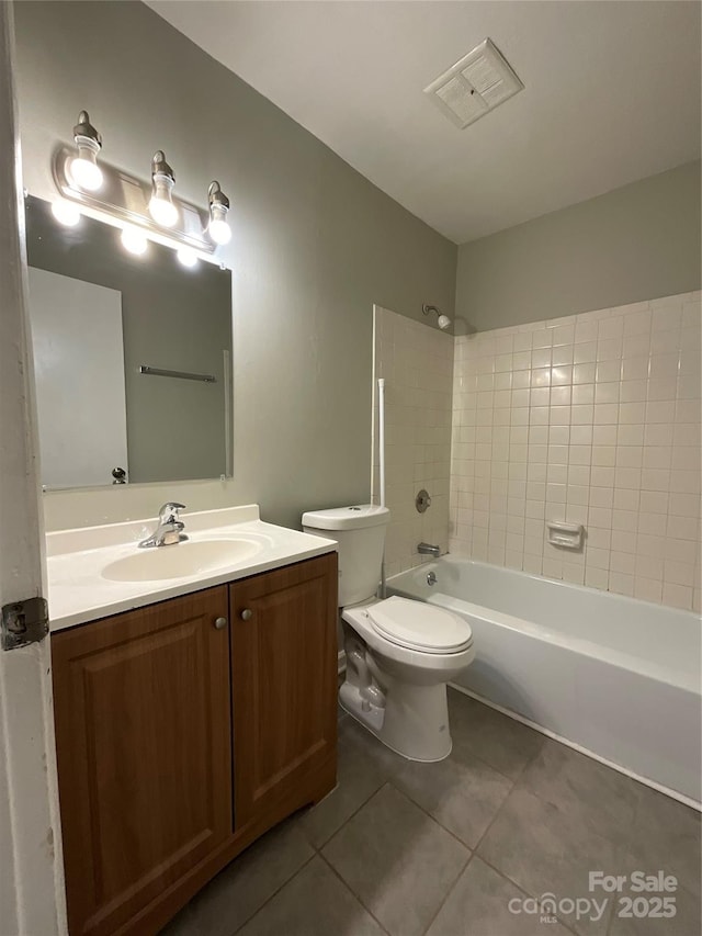 bathroom with visible vents, toilet, washtub / shower combination, vanity, and tile patterned flooring