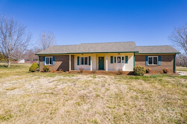 ranch-style home with brick siding and a front yard