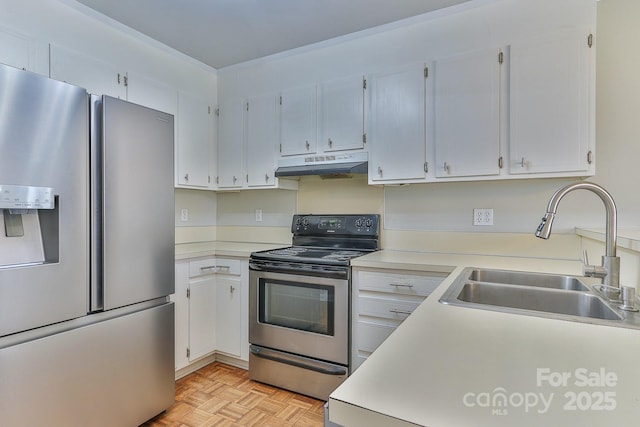 kitchen with under cabinet range hood, light countertops, appliances with stainless steel finishes, white cabinetry, and a sink