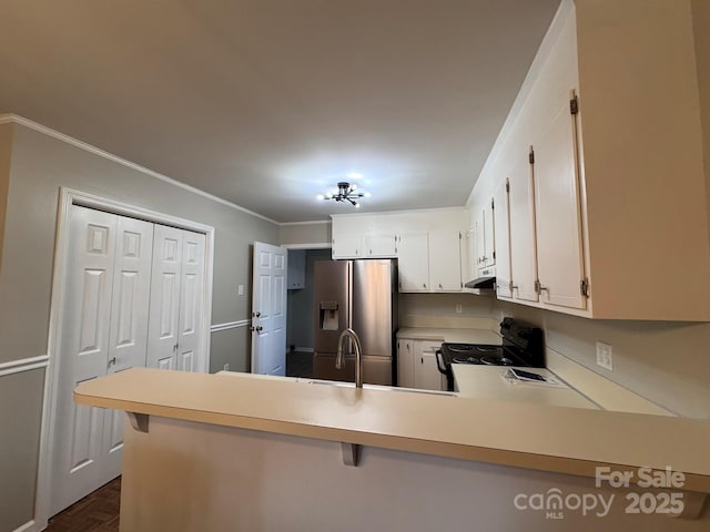 kitchen with a peninsula, extractor fan, black electric range, light countertops, and stainless steel refrigerator with ice dispenser