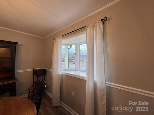 interior space with crown molding, baseboards, and wood finished floors