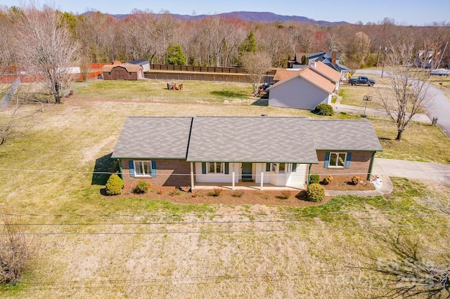 drone / aerial view featuring a mountain view and a view of trees