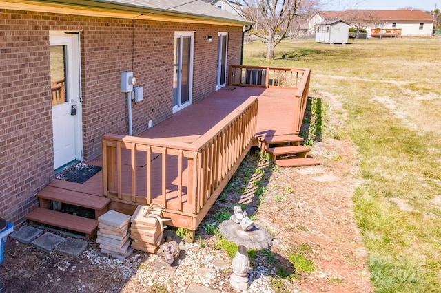 wooden deck featuring a yard