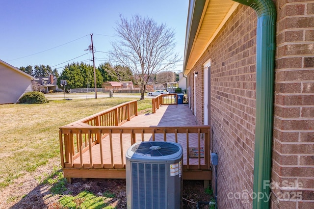 wooden terrace featuring a yard and central AC