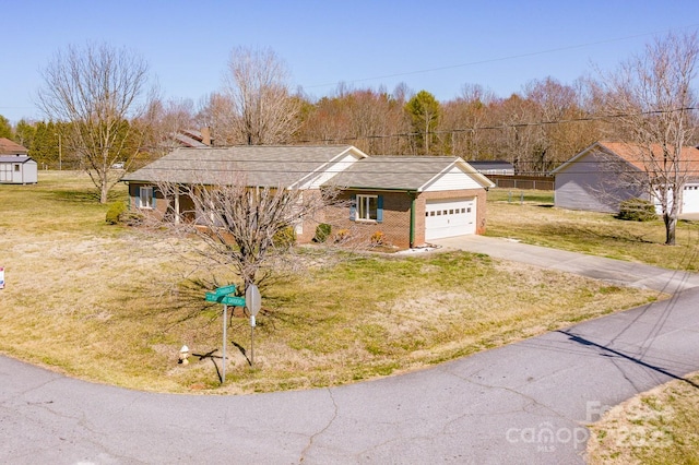 ranch-style house with concrete driveway, an attached garage, brick siding, and a front lawn