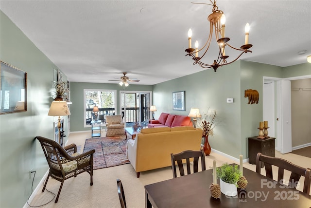 dining space featuring ceiling fan with notable chandelier, baseboards, and carpet