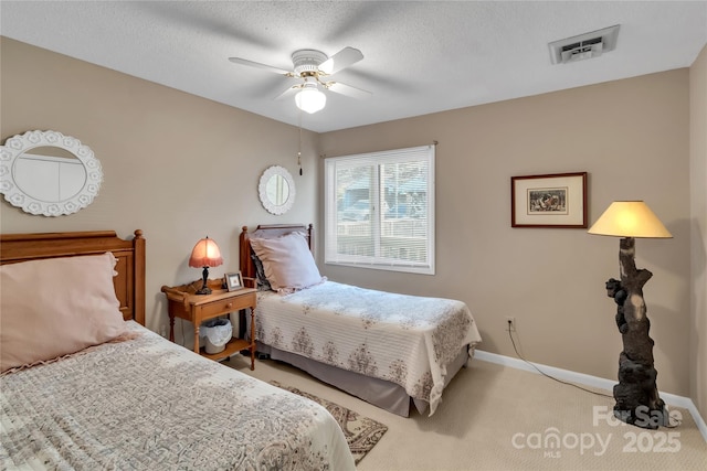 bedroom featuring visible vents, baseboards, carpet, and a textured ceiling