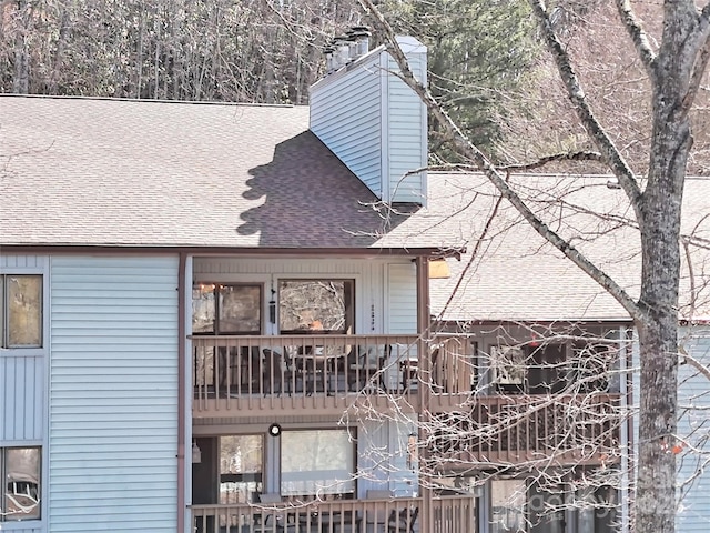 exterior space with roof with shingles