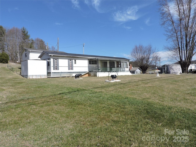 rear view of house with a lawn