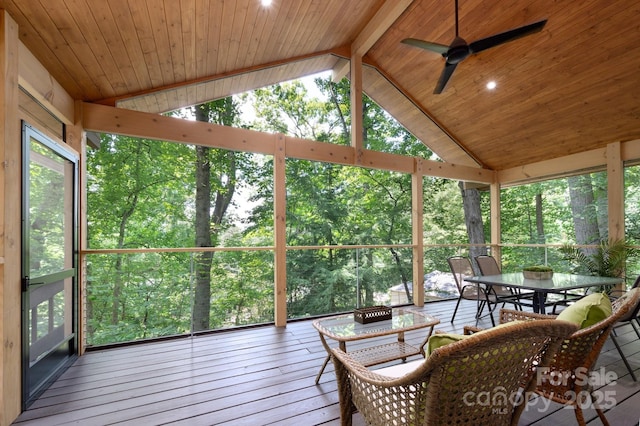 sunroom / solarium with a ceiling fan, lofted ceiling with beams, wooden ceiling, and a wealth of natural light