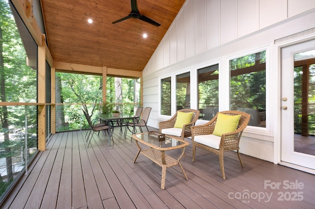 sunroom / solarium with vaulted ceiling, wood ceiling, and ceiling fan