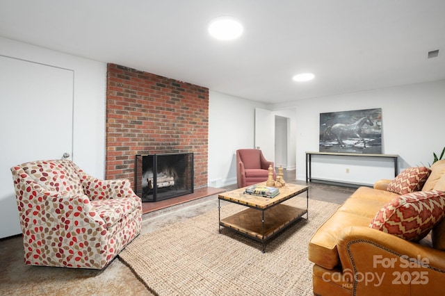 living area featuring recessed lighting, a brick fireplace, and baseboards