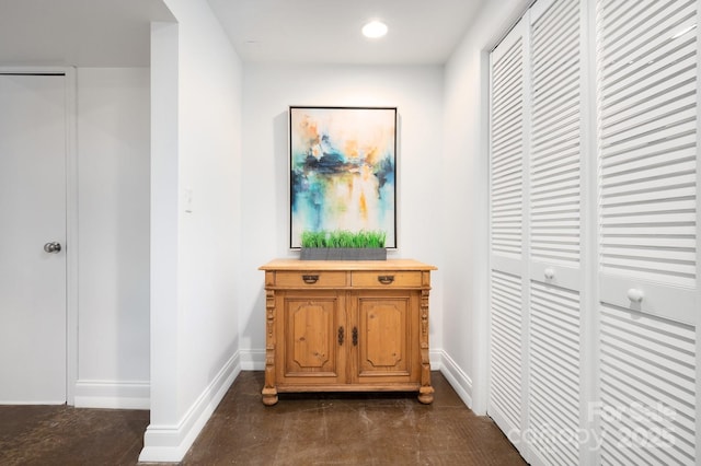 hall featuring recessed lighting and baseboards