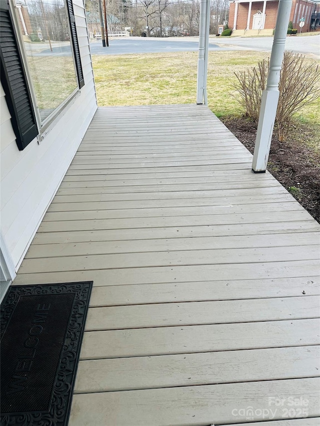 wooden deck featuring a yard