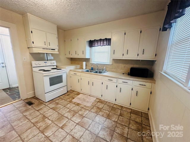 kitchen featuring white electric range oven, visible vents, light countertops, a sink, and under cabinet range hood