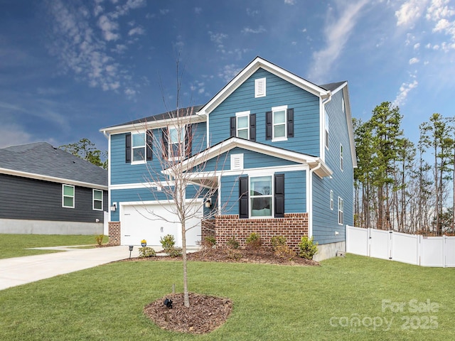 traditional home with a front yard, fence, driveway, a garage, and brick siding