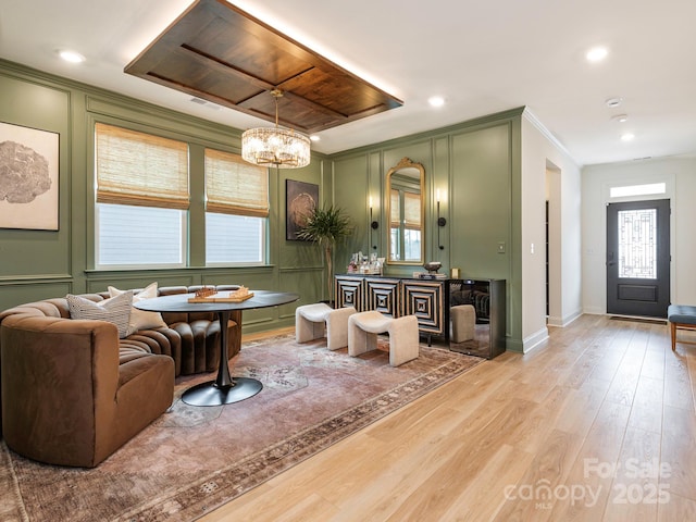 interior space with a wealth of natural light, wood finished floors, ornamental molding, and a decorative wall