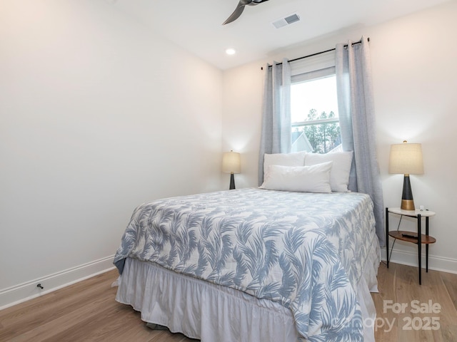 bedroom featuring visible vents, a ceiling fan, wood finished floors, recessed lighting, and baseboards