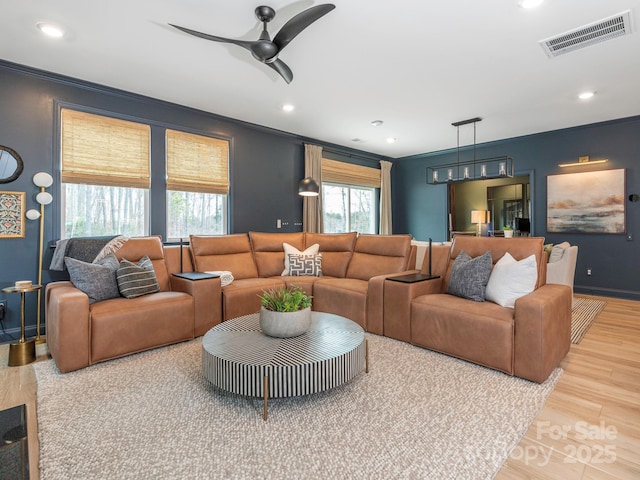 living area with visible vents, crown molding, ceiling fan, recessed lighting, and light wood-style floors