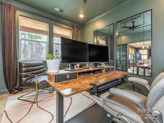 home office with visible vents, crown molding, and wood finished floors