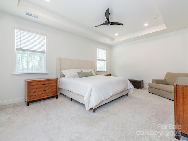 carpeted bedroom with visible vents, recessed lighting, baseboards, crown molding, and a raised ceiling