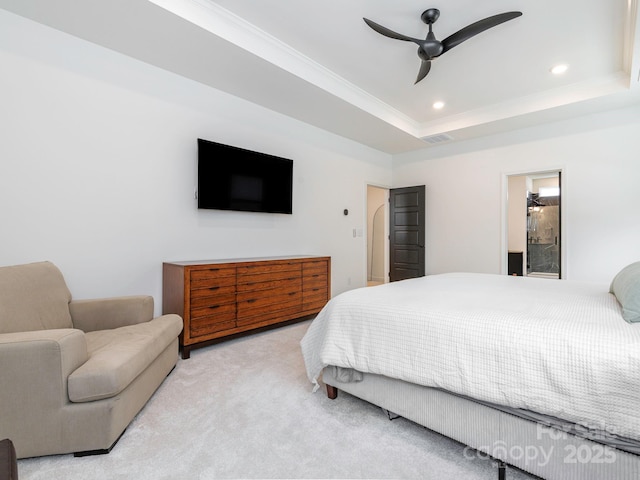 carpeted bedroom featuring a tray ceiling, crown molding, recessed lighting, and ceiling fan