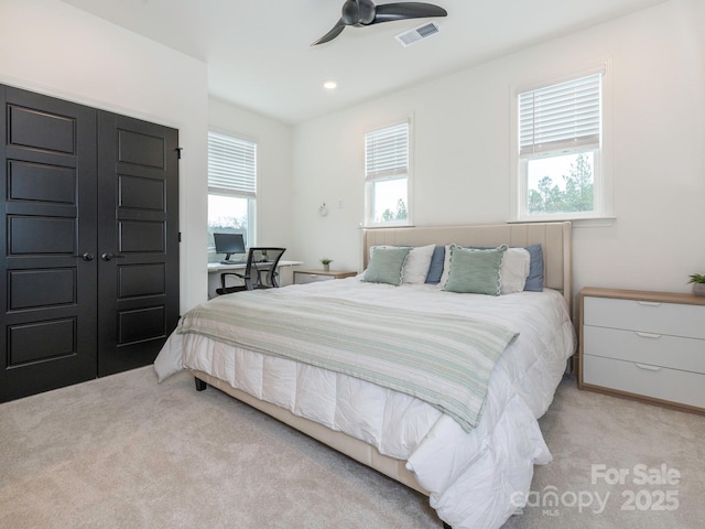 carpeted bedroom with recessed lighting, visible vents, multiple windows, and ceiling fan