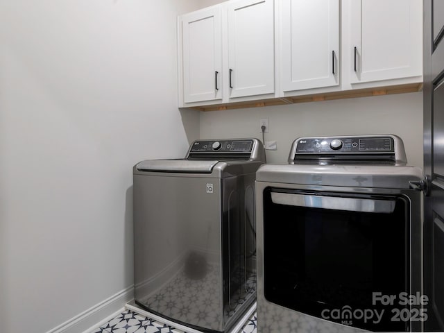 laundry room featuring tile patterned floors, baseboards, cabinet space, and washing machine and dryer