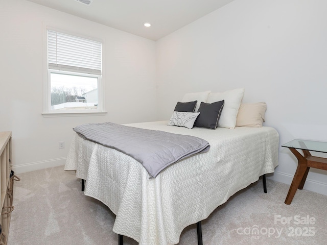 bedroom with recessed lighting, baseboards, and light carpet