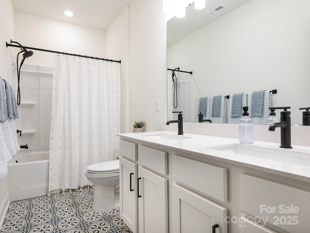 bathroom featuring tile patterned flooring, toilet, visible vents, and a sink