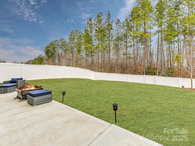 view of yard featuring a patio, a fenced backyard, and an outdoor fire pit