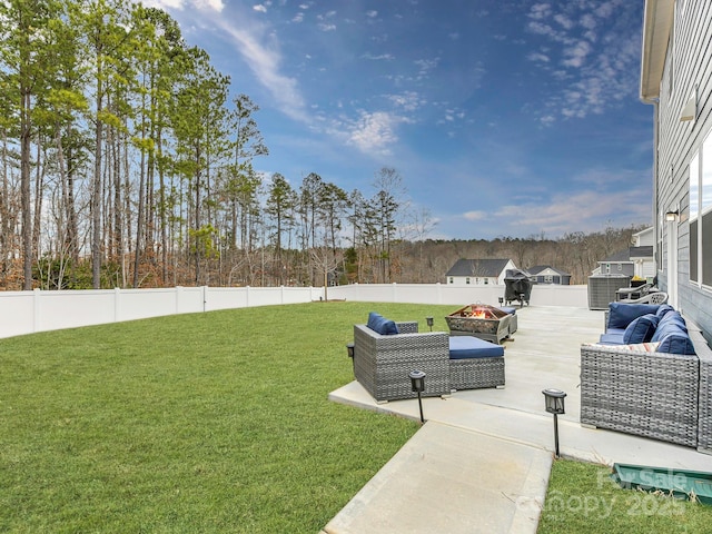 view of yard featuring a patio area, an outdoor living space with a fire pit, and a fenced backyard