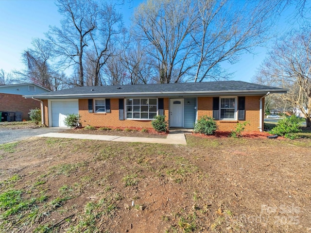 ranch-style home featuring brick siding, a garage, and driveway