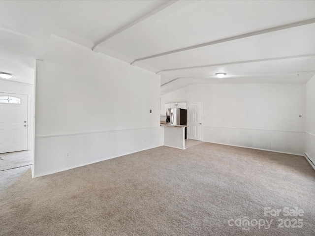 interior space with lofted ceiling with beams and carpet