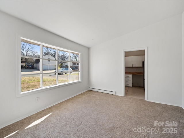 unfurnished room featuring baseboards, lofted ceiling, baseboard heating, and carpet flooring