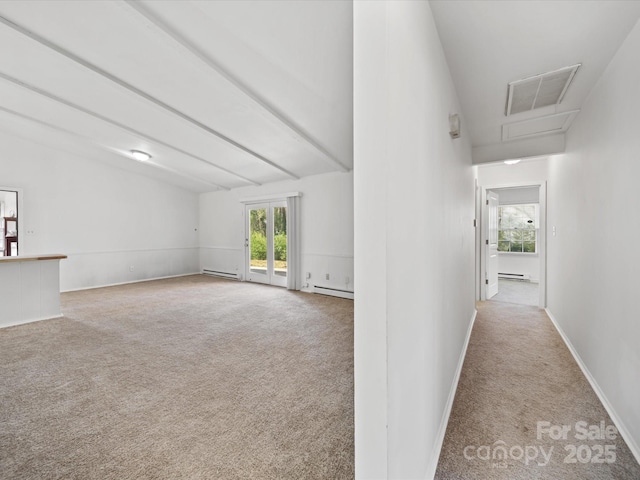 interior space with visible vents, baseboard heating, and carpet