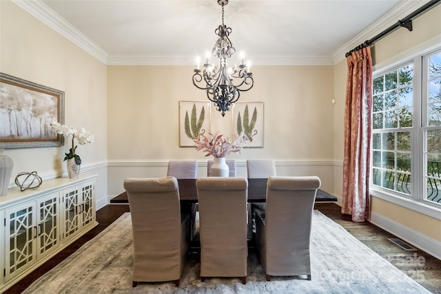 dining area with visible vents, plenty of natural light, crown molding, and wood finished floors