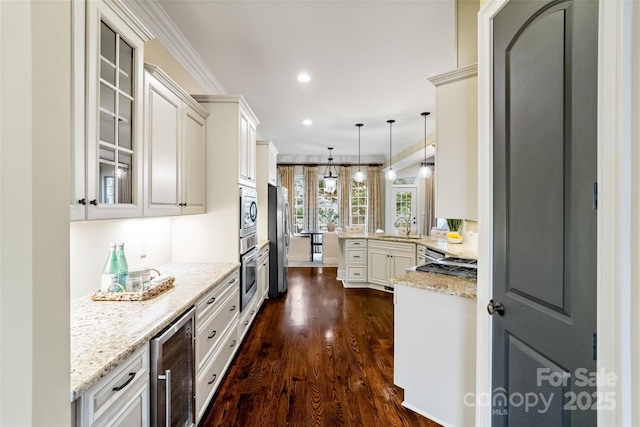 kitchen with beverage cooler, dark wood-style flooring, a sink, glass insert cabinets, and appliances with stainless steel finishes