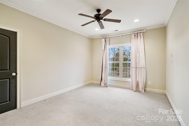 empty room featuring visible vents, baseboards, ceiling fan, crown molding, and carpet flooring