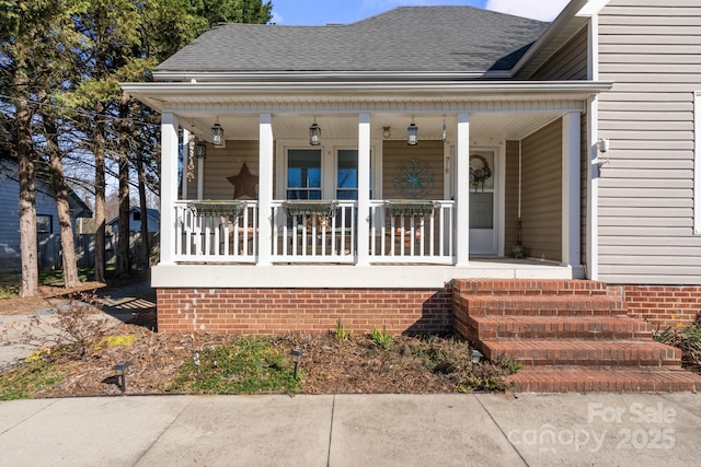 view of front of house featuring covered porch and roof with shingles