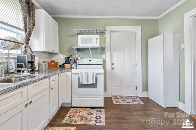 kitchen featuring white appliances, dark wood-style flooring, a sink, white cabinetry, and light stone countertops