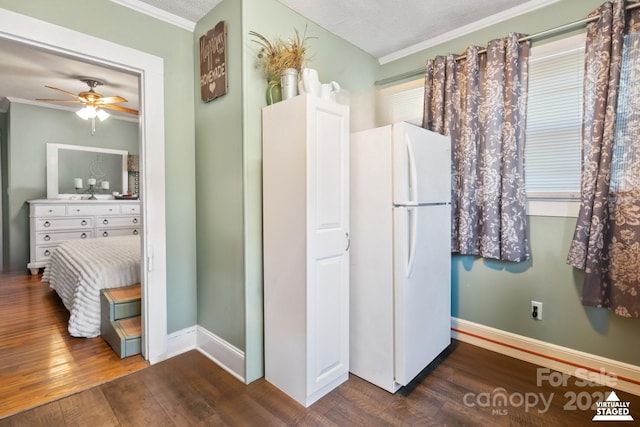 bathroom featuring ornamental molding, baseboards, and wood finished floors