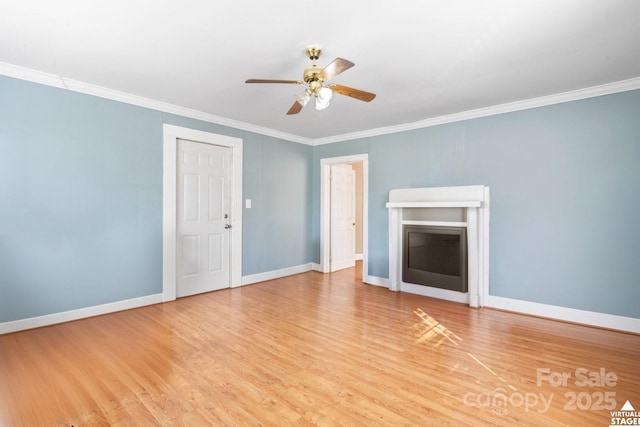 unfurnished living room featuring ornamental molding, light wood-type flooring, baseboards, and a ceiling fan