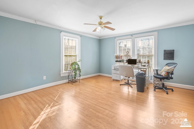 office featuring a healthy amount of sunlight, baseboards, ornamental molding, and wood finished floors