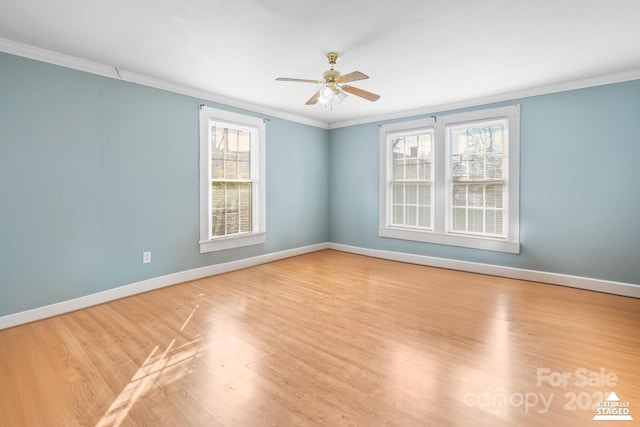 unfurnished room featuring ceiling fan, baseboards, crown molding, and wood finished floors