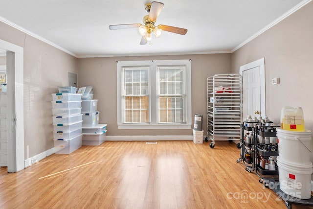 miscellaneous room with ceiling fan, ornamental molding, wood finished floors, and baseboards