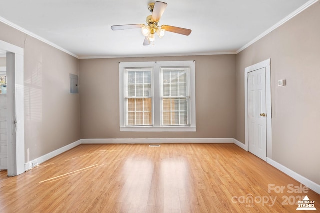 unfurnished room featuring light wood-style floors, baseboards, and ornamental molding