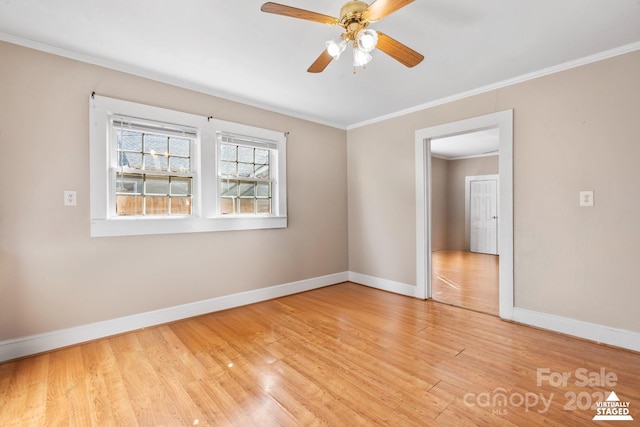 empty room with a ceiling fan, baseboards, crown molding, and light wood finished floors
