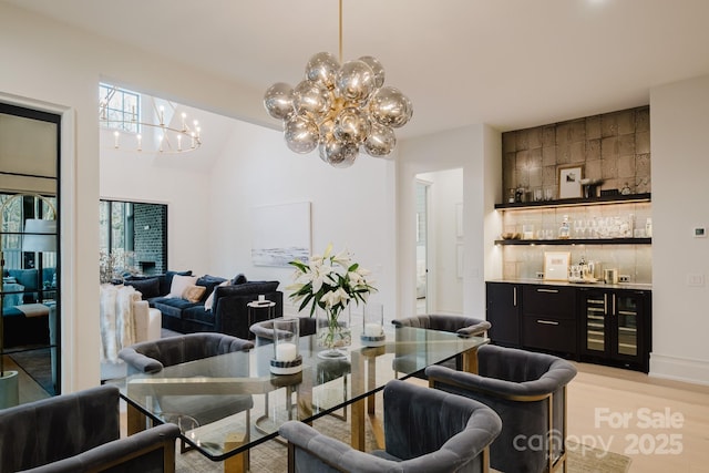 dining space with wine cooler, plenty of natural light, and a dry bar